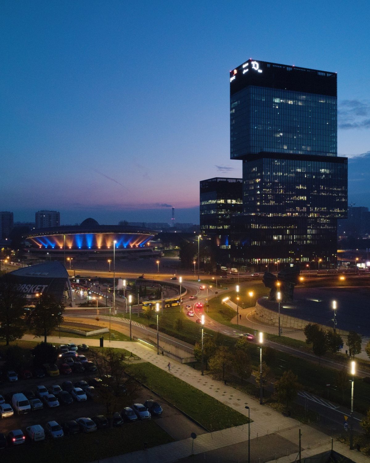 Dusk aerial of central Katowice with the illuminated Spodek arena and the .KTW office towers
