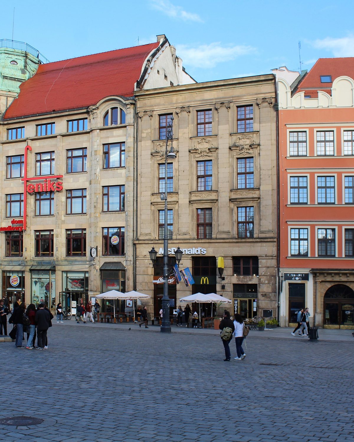 Wrocław's Market Square at street level, with café tables outside the painted townhouses