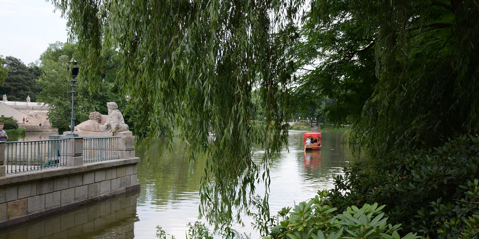 Willows over the pond in Warsaw's Łazienki Park on a summer afternoon