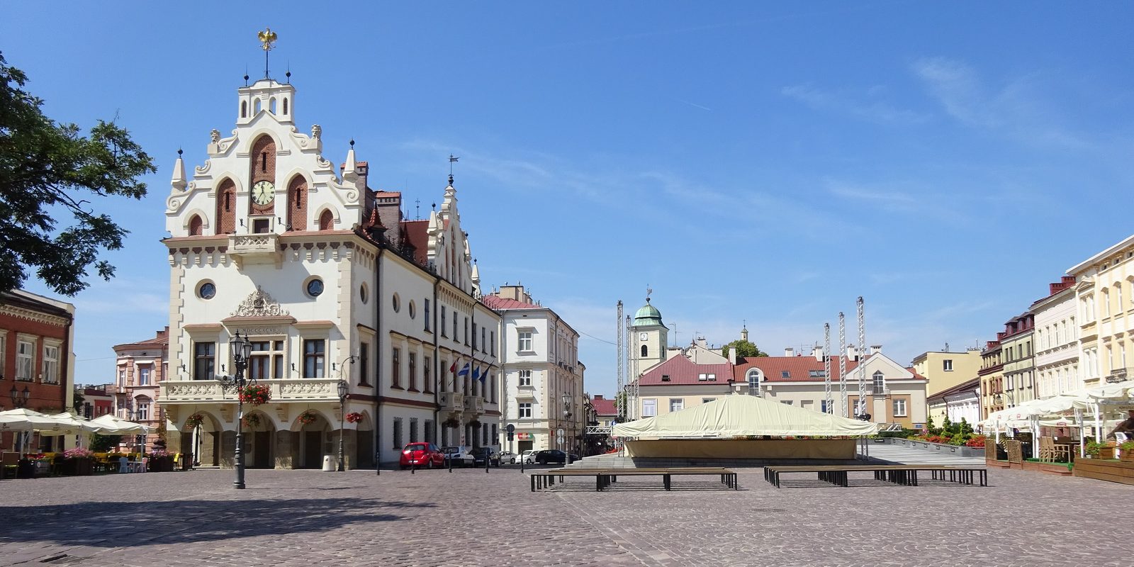 Rzeszów's market square with the town hall tower and the fountain, seen across the open paving