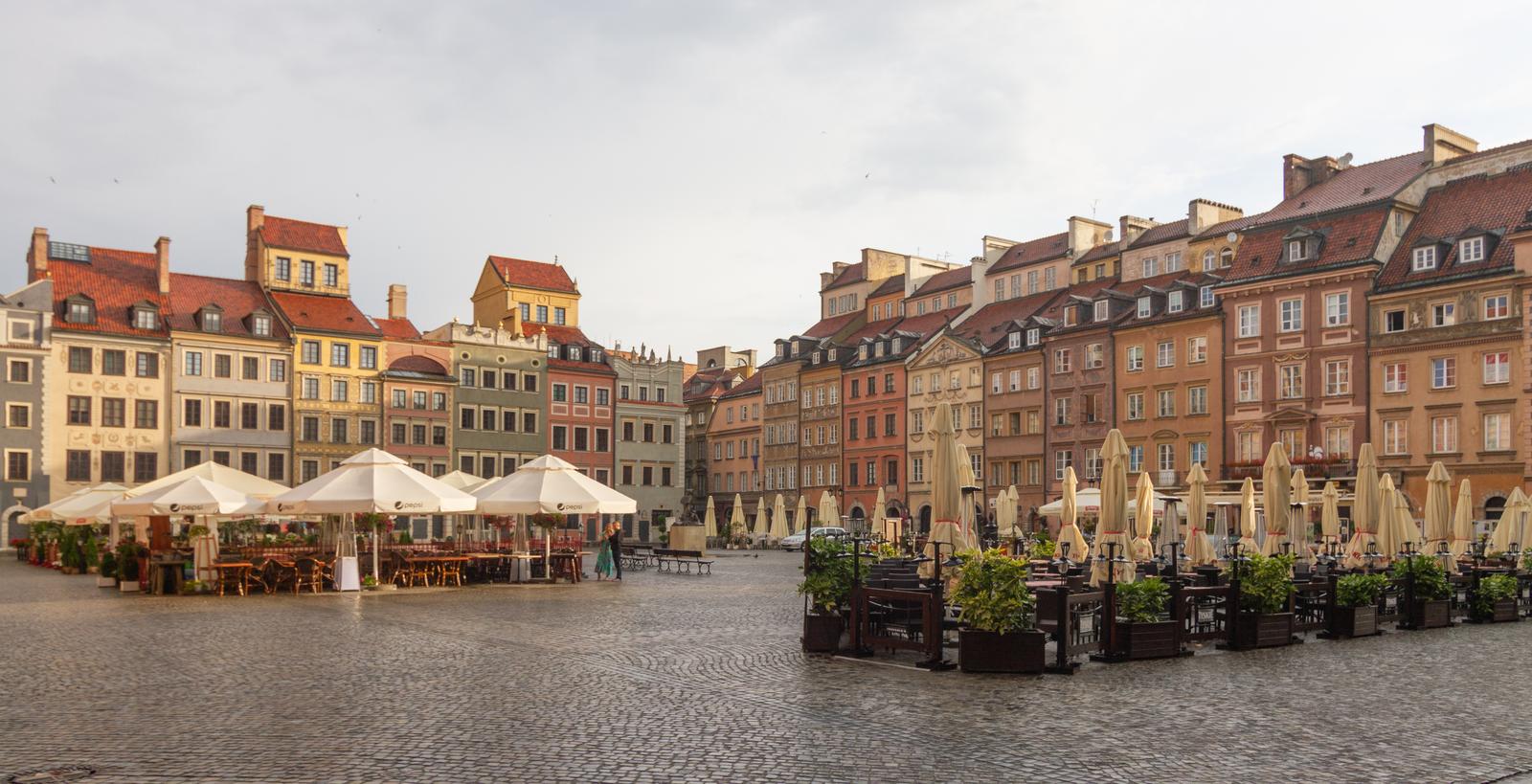 Warsaw Old Town Market Square with colourful reconstructed townhouses and outdoor café terraces