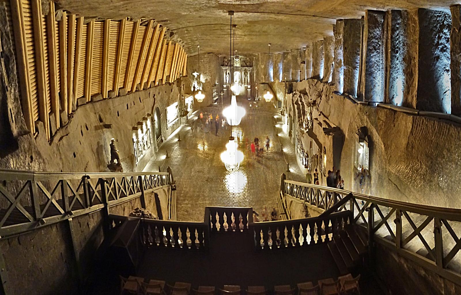 Underground chamber of the Wieliczka Salt Mine with chandeliers and carved wooden pillars