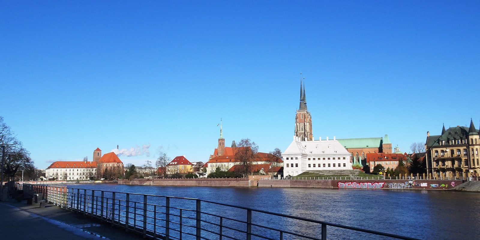 Ostrów Tumski in Wrocław seen across the Odra river, with the cathedral spires against a clear winter sky