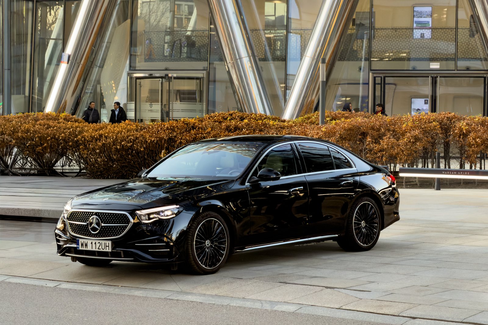 A black Mercedes E-Class waiting outside the Warsaw Spire office tower